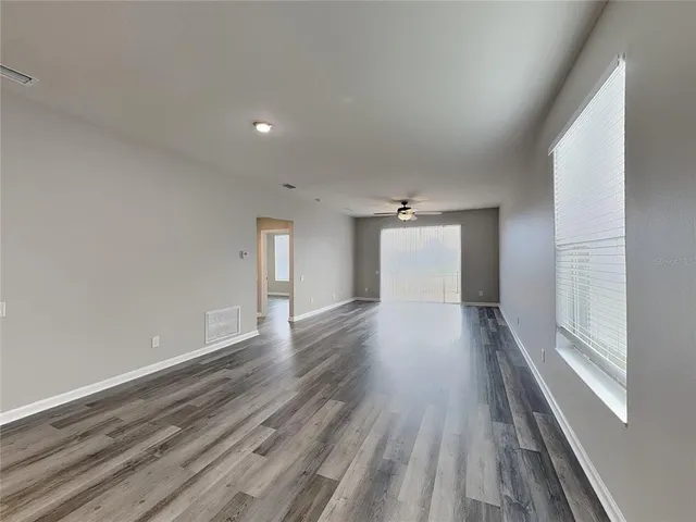 a view of a room with wooden floor and window