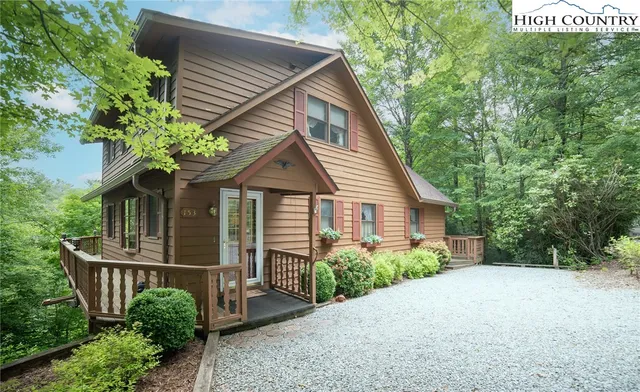 a front view of a house with plants