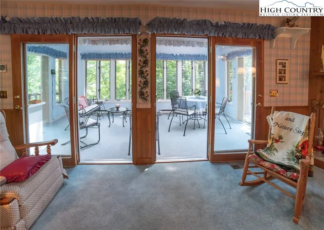 a view of a livingroom with furniture and a floor to ceiling window