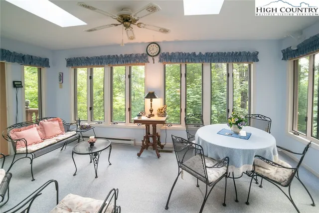 a dining room with furniture a chandelier and a rug