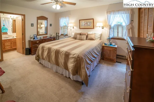 a spacious bedroom with a bed and a chandelier