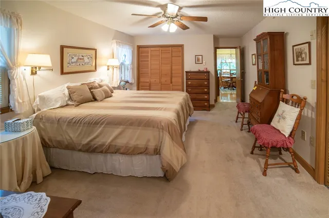 a spacious bedroom with a bed a couch and dresser