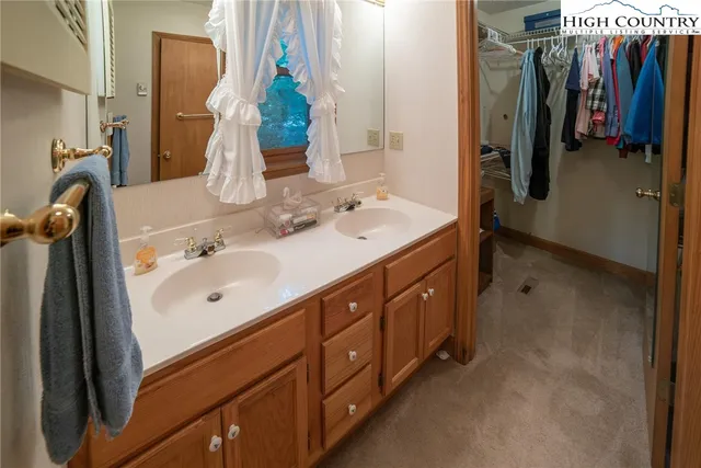a spacious bathroom with a double vanity sink and a mirror
