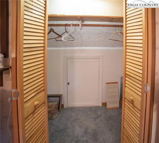 a view of a hallway with a utility room and utility room