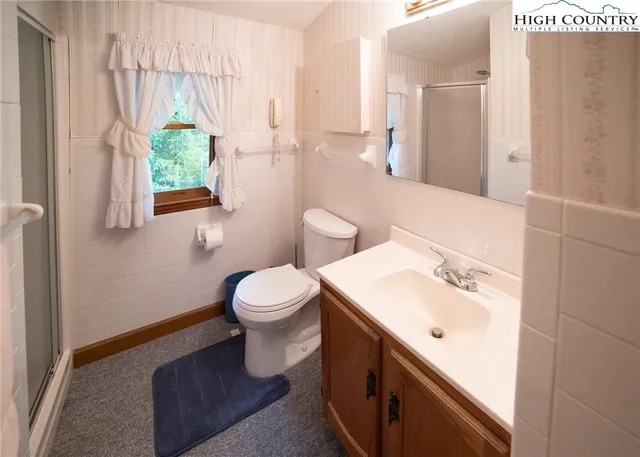 a bathroom with a sink toilet and mirror