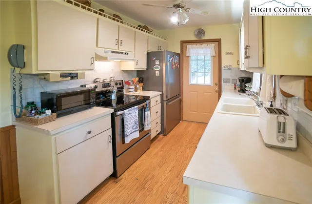 a kitchen with a stove a sink and a refrigerator