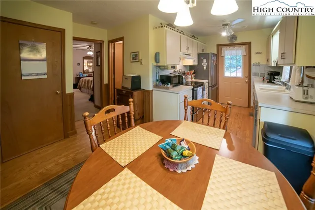 a kitchen with stainless steel appliances kitchen island granite countertop a table and chairs