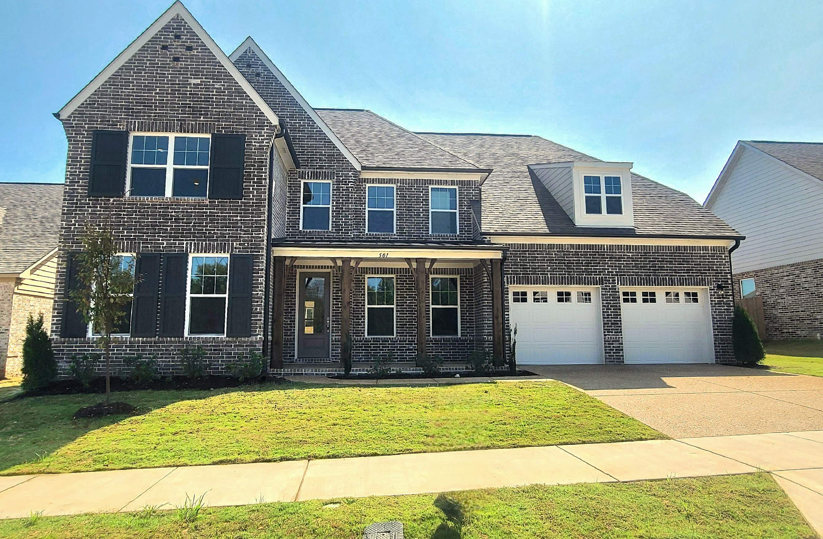 501 Halle Park Drive Collierville, TN 38017 - Photo 1 of 37 a front view of a house with a garden