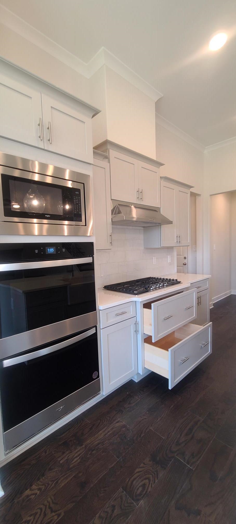 501 Halle Park Drive Collierville, TN 38017 - Photo 11 of 37 a kitchen with granite countertop a stove and a sink