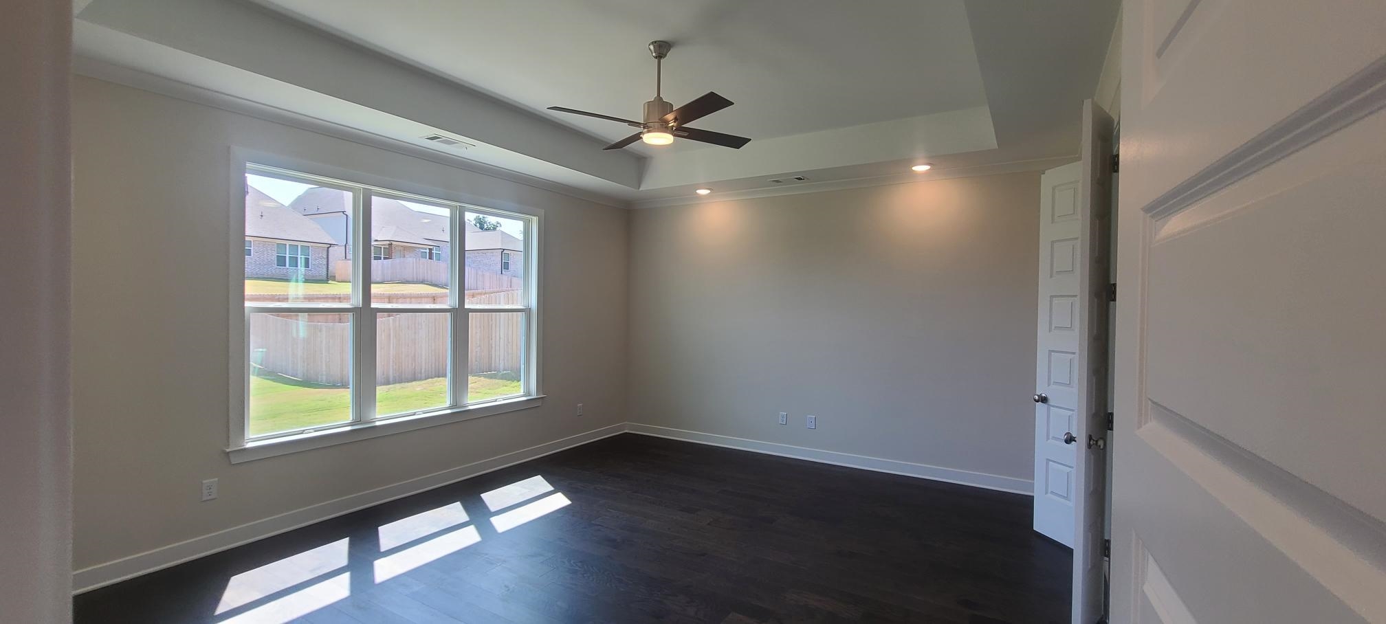 501 Halle Park Drive Collierville, TN 38017 - Photo 17 of 37 an empty room with wooden floor fan and windows