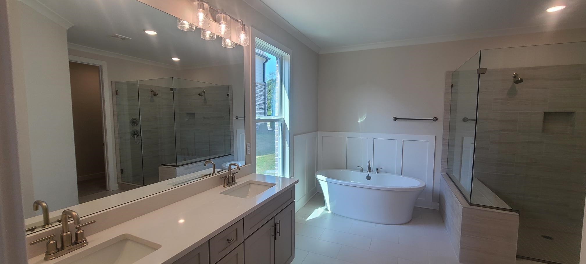 501 Halle Park Drive Collierville, TN 38017 - Photo 18 of 37 a bathroom with a double vanity sink and a mirror