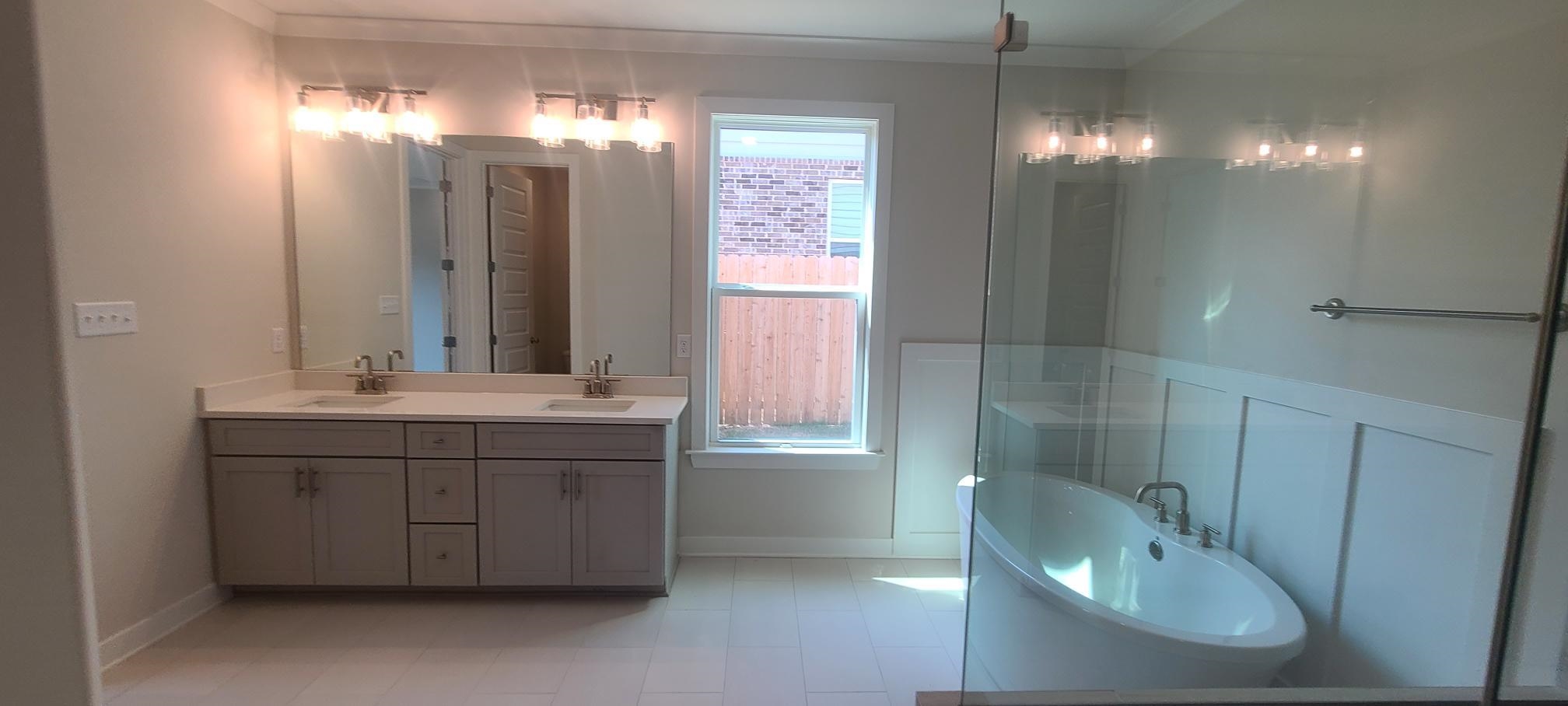 501 Halle Park Drive Collierville, TN 38017 - Photo 19 of 37 a bathroom with a double vanity sink and a mirror