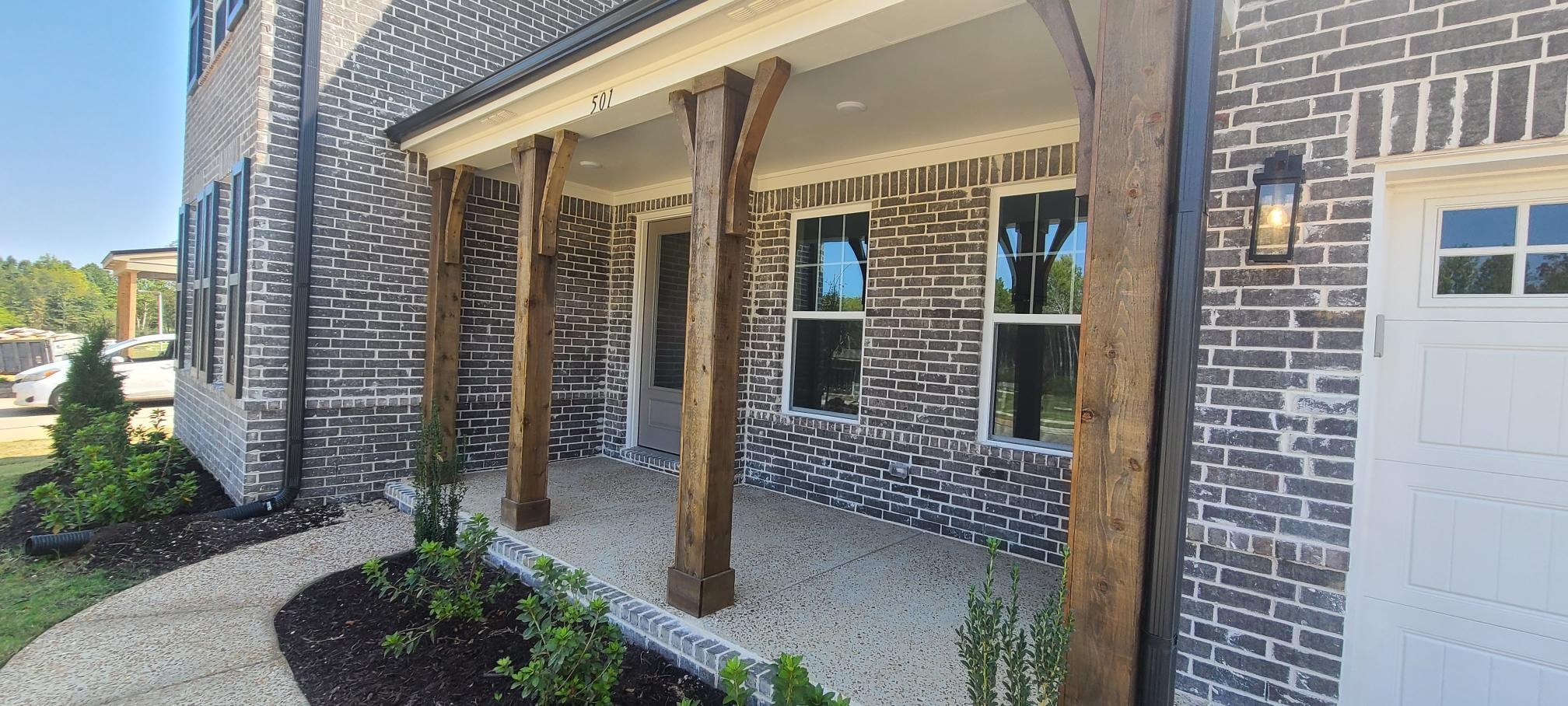 501 Halle Park Drive Collierville, TN 38017 - Photo 2 of 37 a porch with seating space and yard