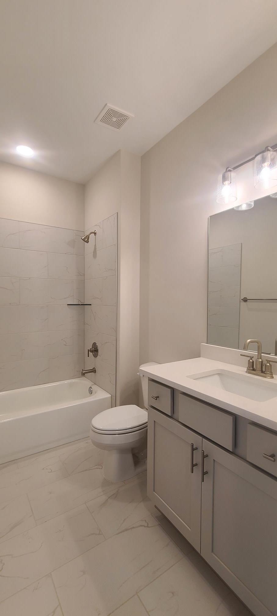 501 Halle Park Drive Collierville, TN 38017 - Photo 4 of 37 a bathroom with a double vanity sink toilet mirror and bathtub