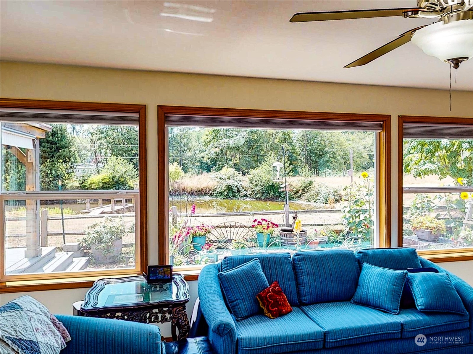 61 Camelot Road Sequim, WA 98382 - Photo 12 of 33 a living room with couch and a floor to ceiling window