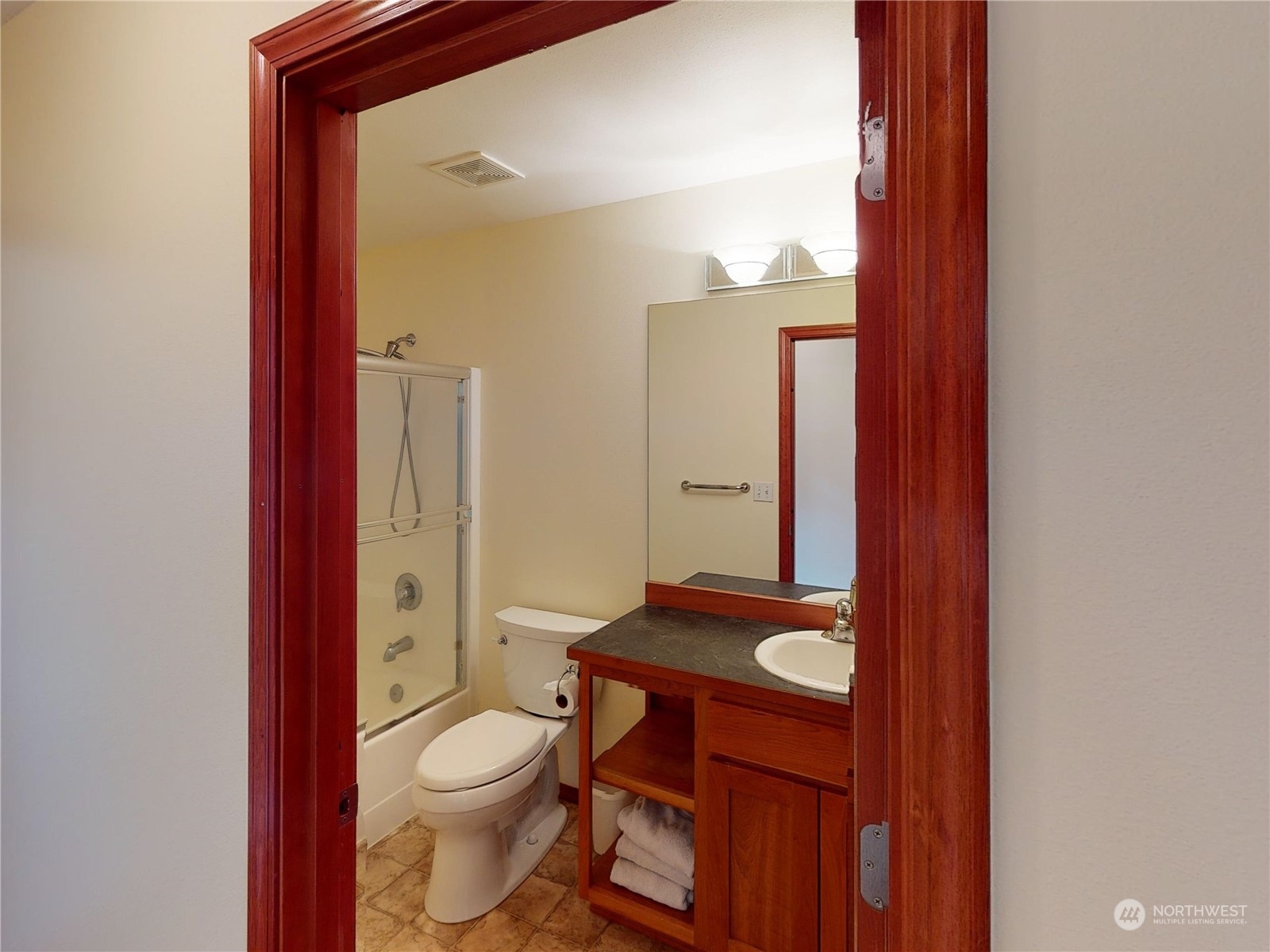61 Camelot Road Sequim, WA 98382 - Photo 16 of 33 a bathroom with a toilet a sink and shower curtain