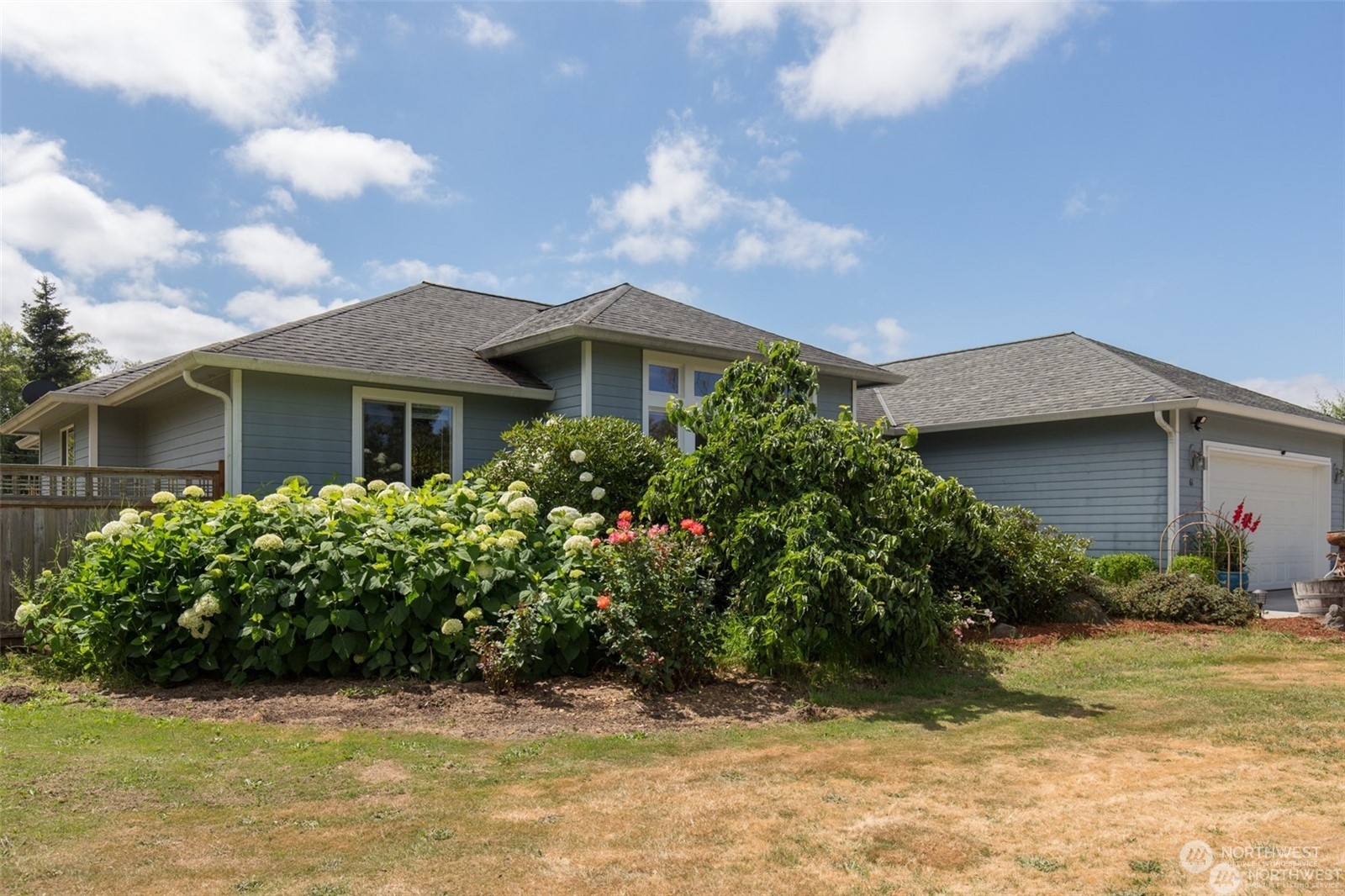 61 Camelot Road Sequim, WA 98382 - Photo 2 of 33 a front view of a house with garden