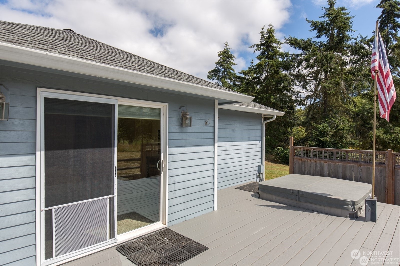 61 Camelot Road Sequim, WA 98382 - Photo 24 of 33 a view of a wooden house with a large window and wooden fence