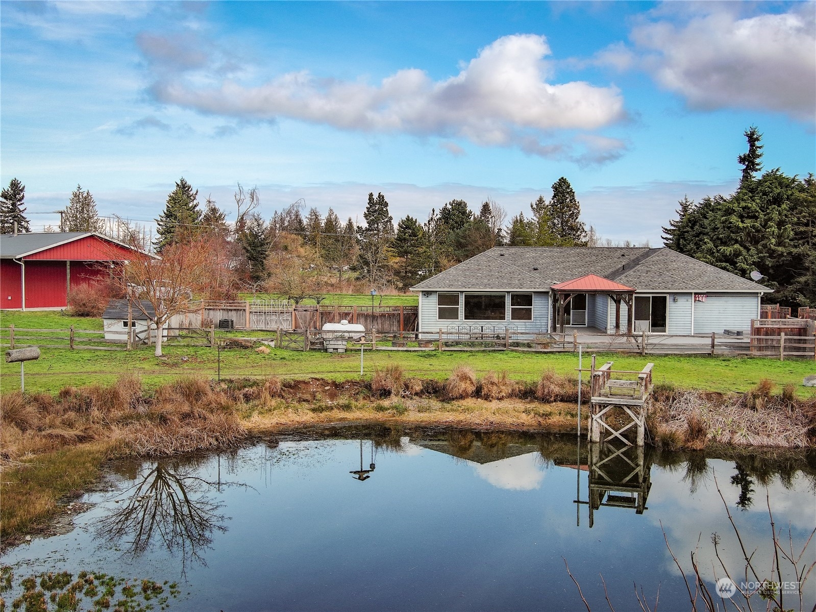 61 Camelot Road Sequim, WA 98382 - Photo 4 of 33 a view of a lake with a house in the background