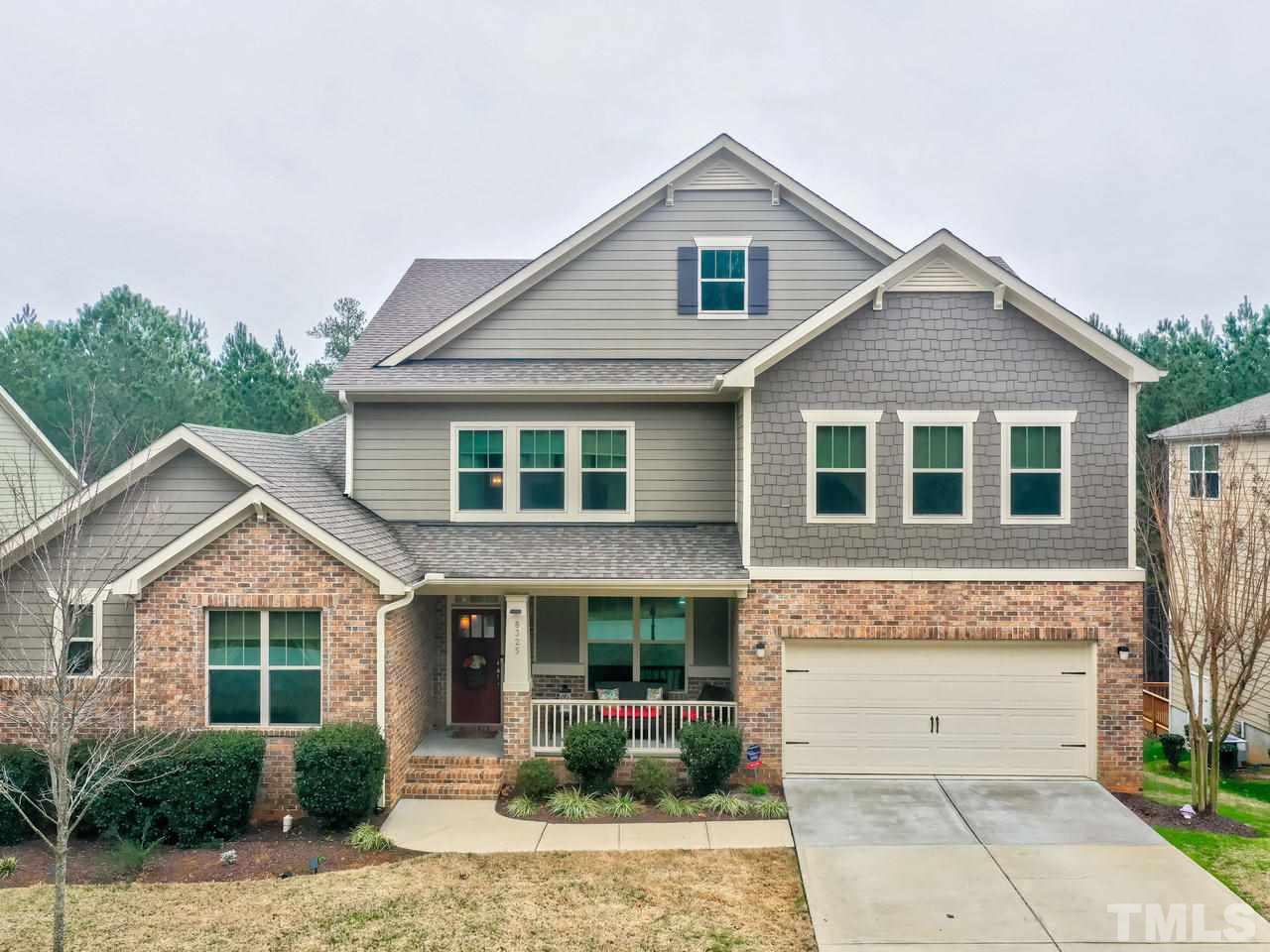 8325 Henderson Road Apex, NC 27539 - Photo 1 of 29 a front view of a house with garden