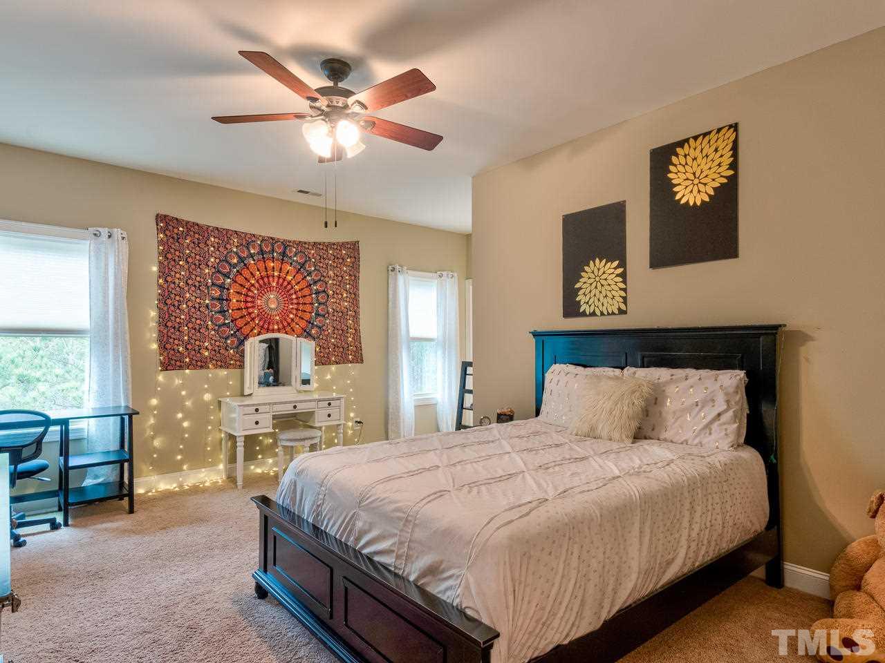 8325 Henderson Road Apex, NC 27539 - Photo 17 of 29 a bedroom with a bed and window