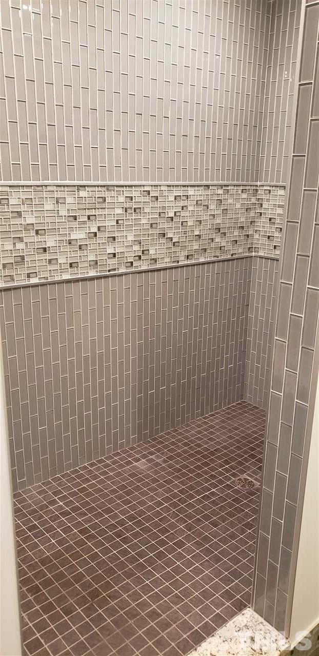 8325 Henderson Road Apex, NC 27539 - Photo 23 of 29 a bathroom with a shower