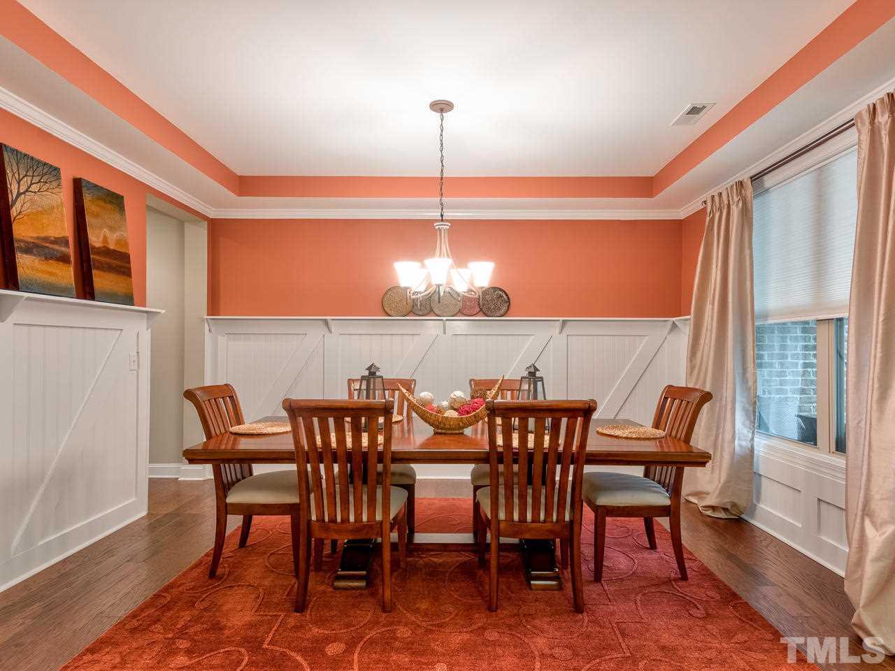 8325 Henderson Road Apex, NC 27539 - Photo 4 of 29 a view of a dining room with furniture window and wooden floor
