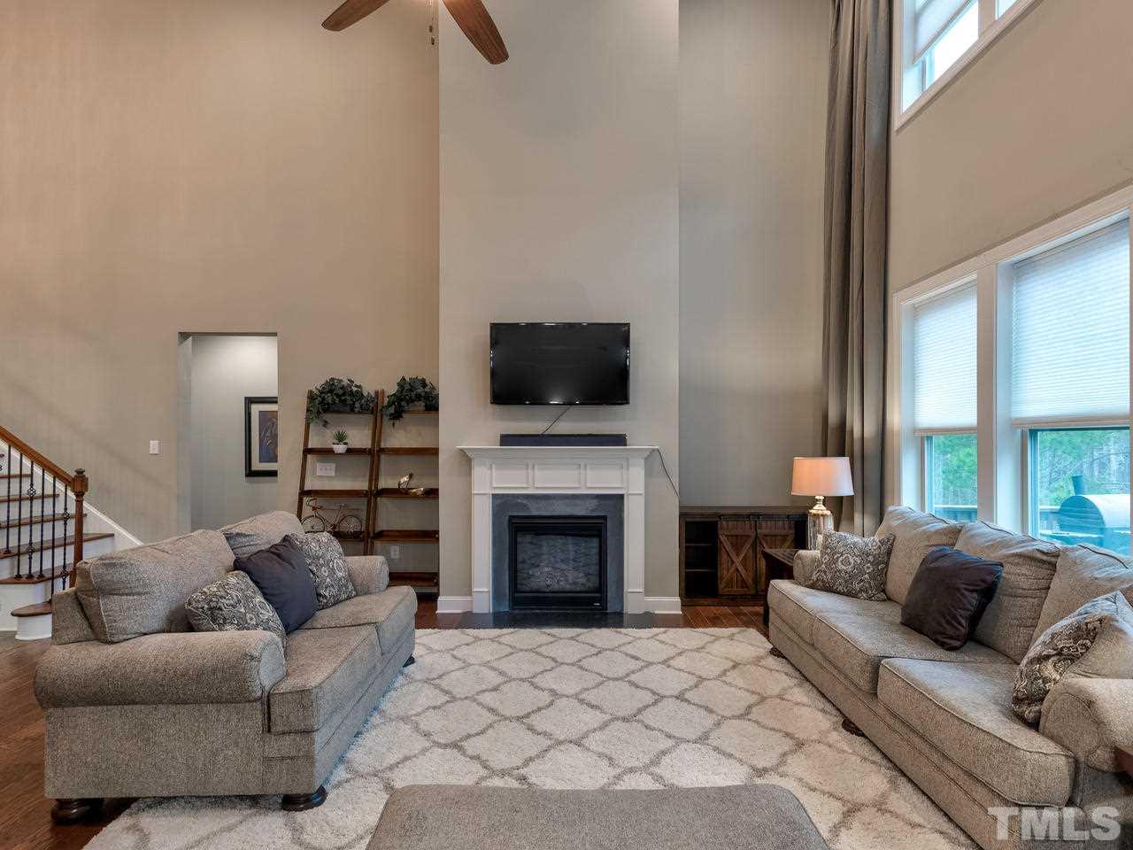 8325 Henderson Road Apex, NC 27539 - Photo 9 of 29 a living room with furniture and a fireplace