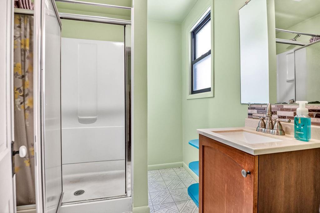 1023 Philadelphia Street Indiana, PA 15701 - Photo 6 of 40 a bathroom with a sink a mirror and a shower