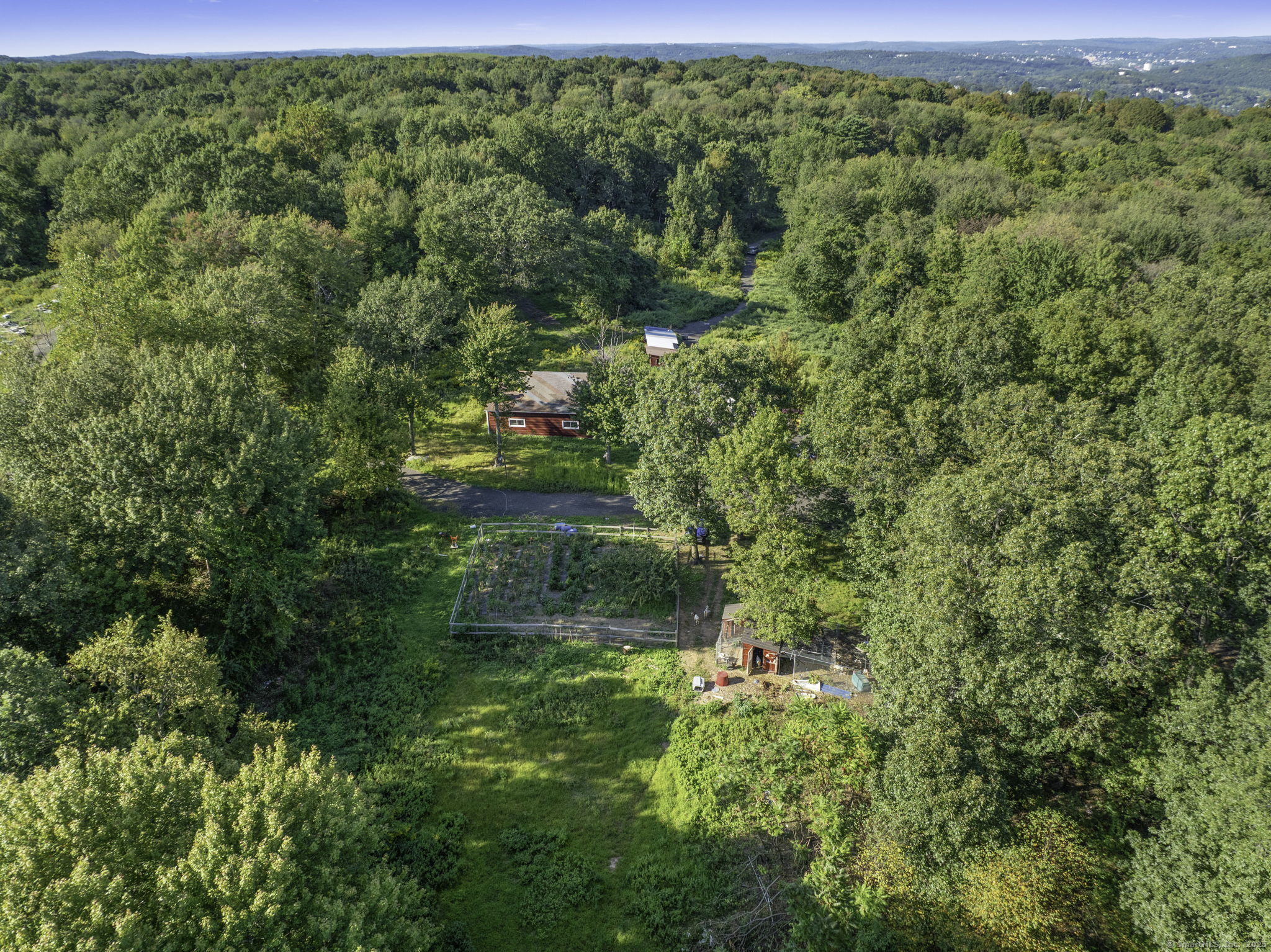 100 Hunters Mountain Road Naugatuck, CT 06770 - Photo 2 of 16 a view of a garden with a tree