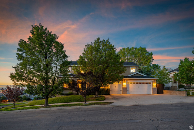 14883 Tooele Lane Draper, UT 84020 - Photo 45 of 49 Contemporary exterior with a multi-car garage, stone veneer accents, and mature trees