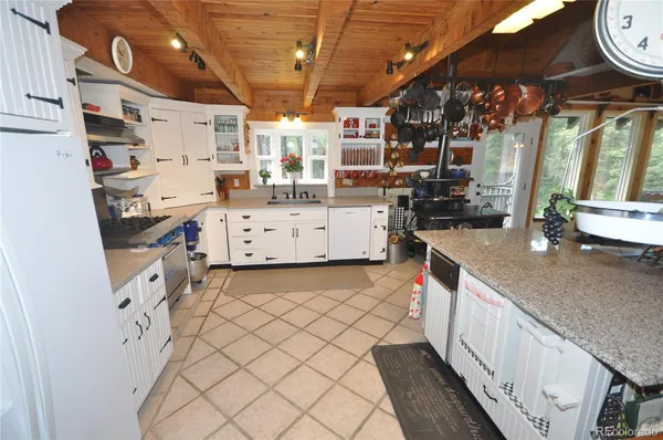 a kitchen with stainless steel appliances a stove a sink and a refrigerator