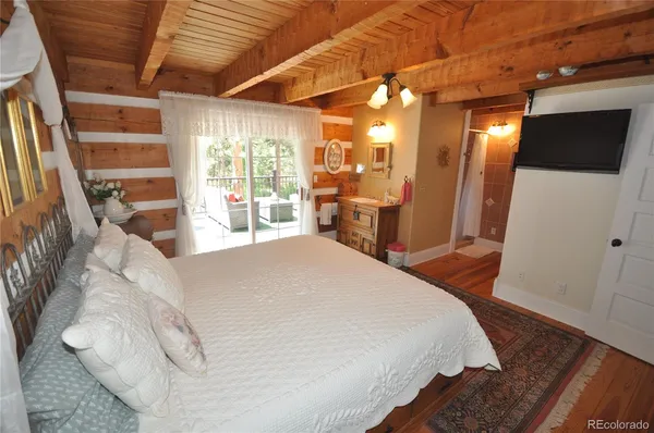 a bed room with a bed and a television