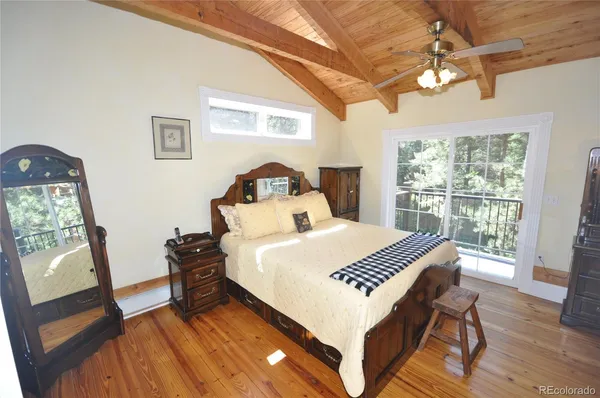 a living room with a bed furniture and a window