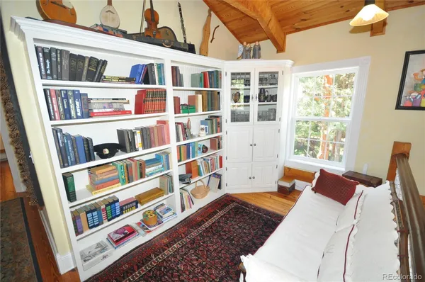 a bed room with a bed and a book shelf