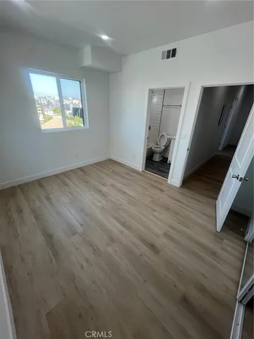 a bathroom with a granite countertop sink toilet a mirror and shower
