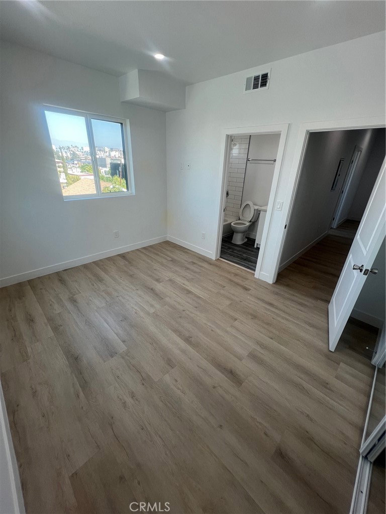 1128 South Ardmore Avenue Los Angeles, CA 90006 - Photo 18 of 30 a view of an empty room with a window