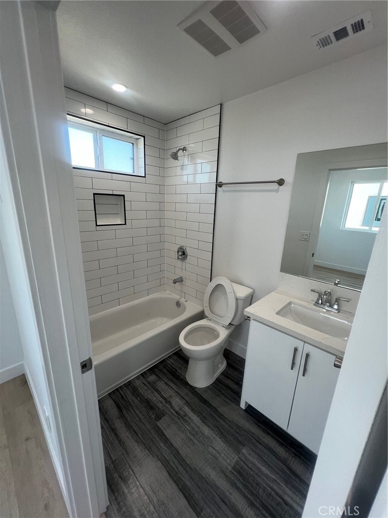 1128 South Ardmore Avenue Los Angeles, CA 90006 - Photo 25 of 30 a bathroom with a toilet sink and mirror