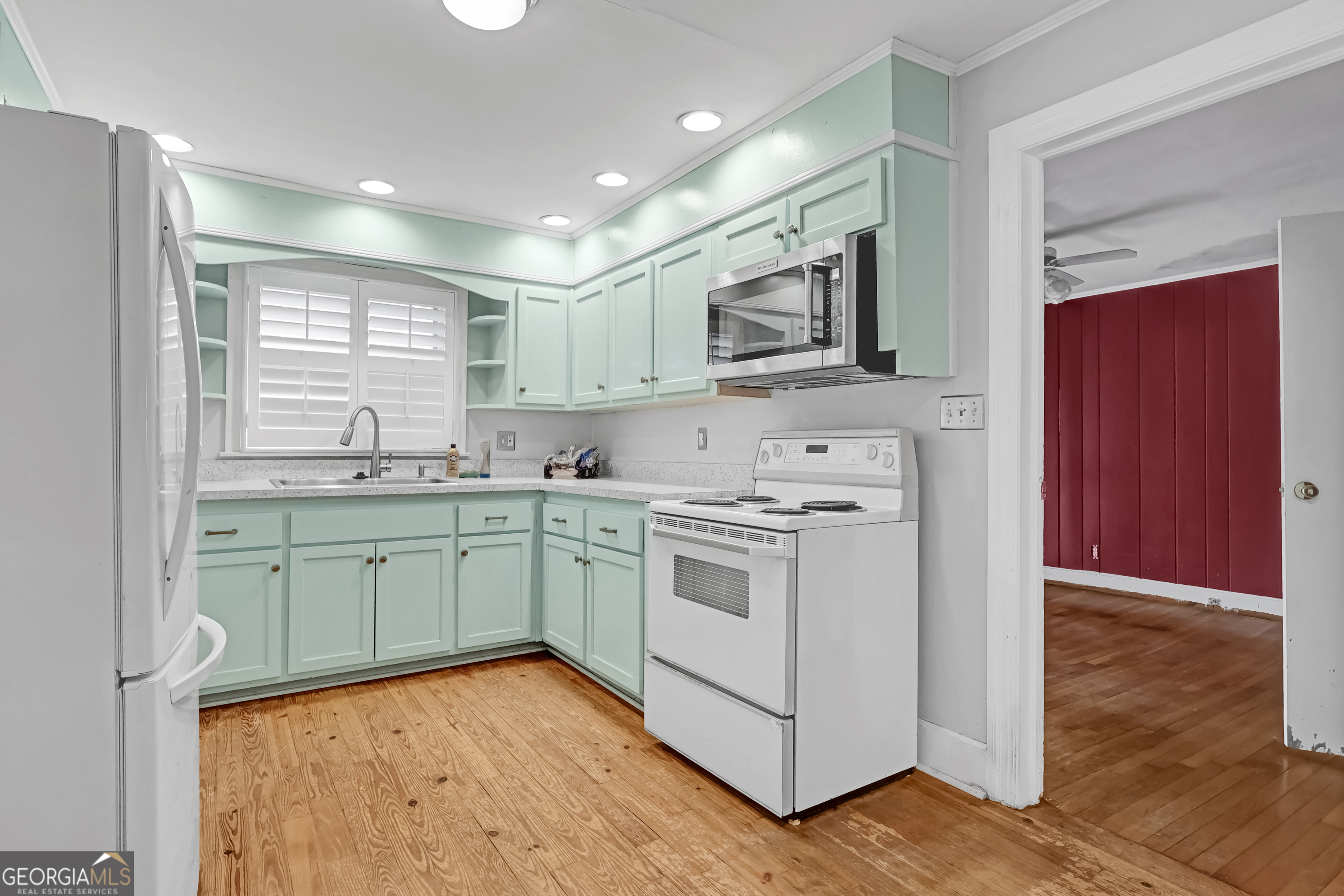 1077 Helen Street Morrow, GA 30260 - Photo 8 of 18 a kitchen with a sink cabinets and wooden floor