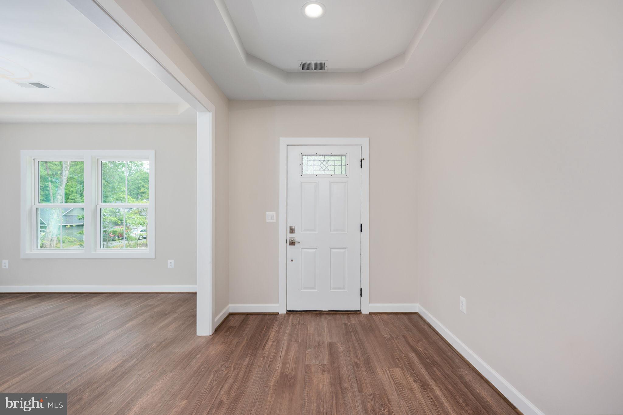 107 Gold Valley Road Locust Grove, VA 22508 - Photo 11 of 19 an empty room with wooden floor and windows