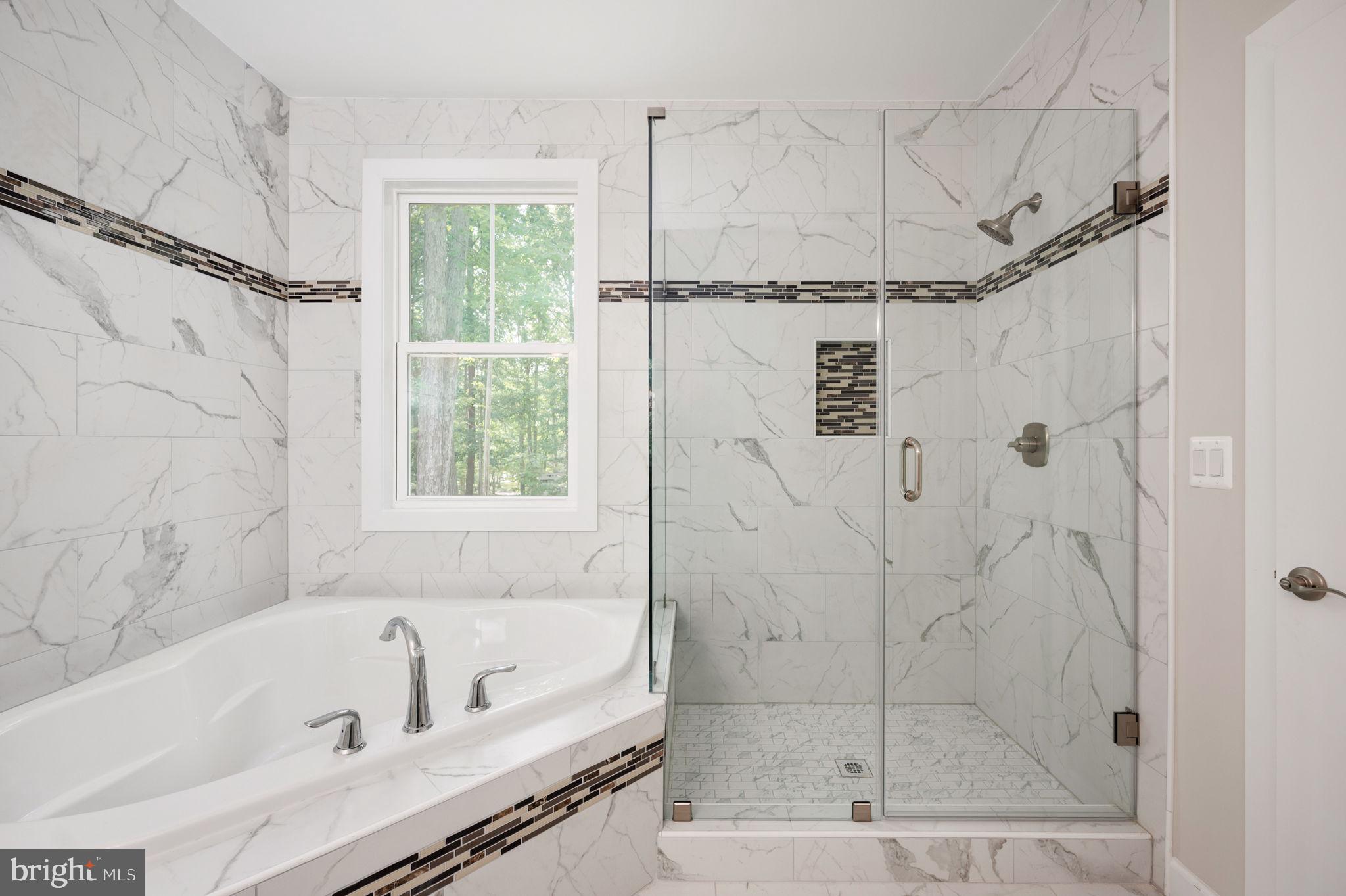 107 Gold Valley Road Locust Grove, VA 22508 - Photo 12 of 19 a bathroom with a bath tub a window and a shower