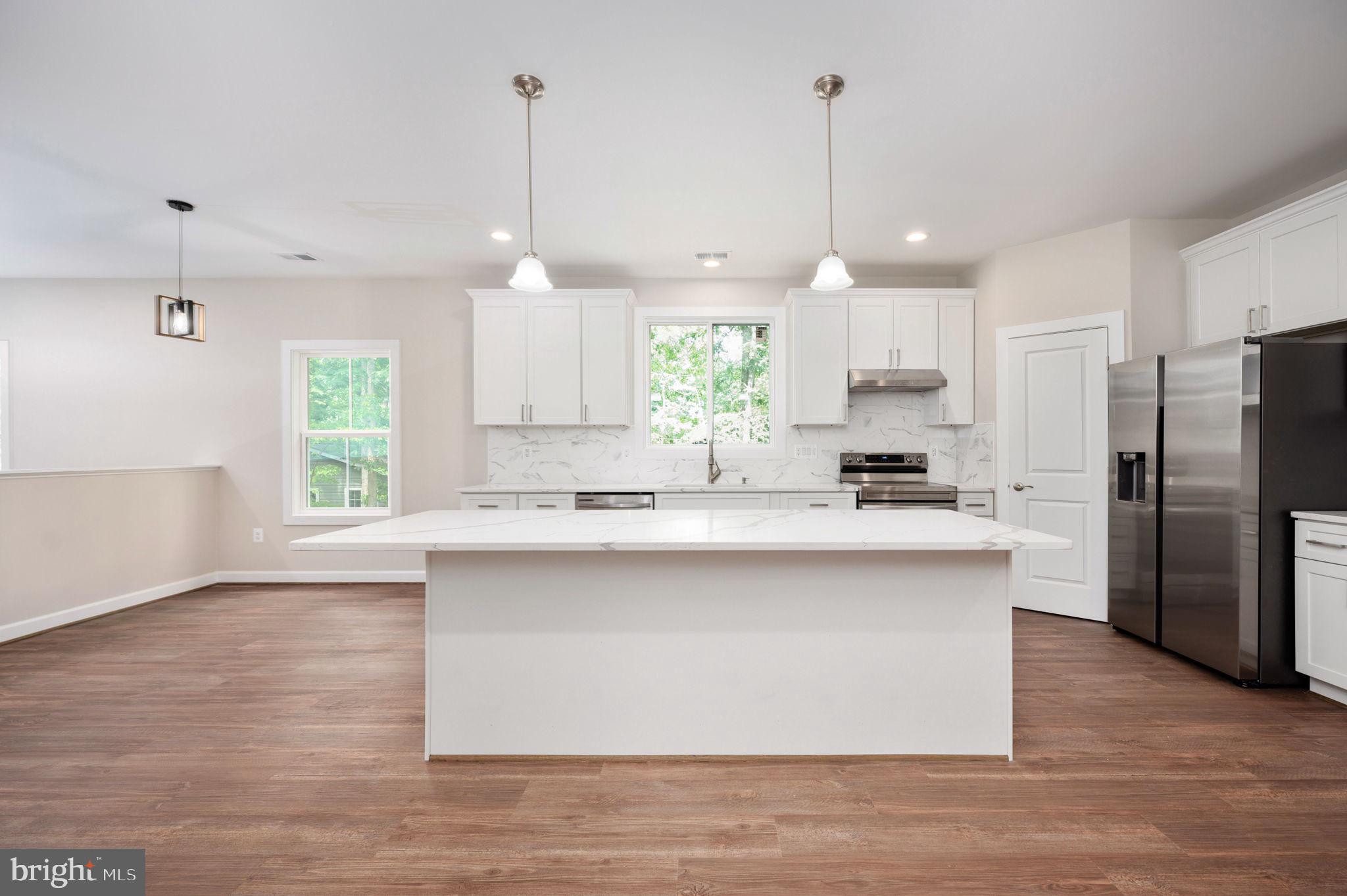 107 Gold Valley Road Locust Grove, VA 22508 - Photo 4 of 19 a large kitchen with granite countertop a large window stainless steel appliances and cabinets