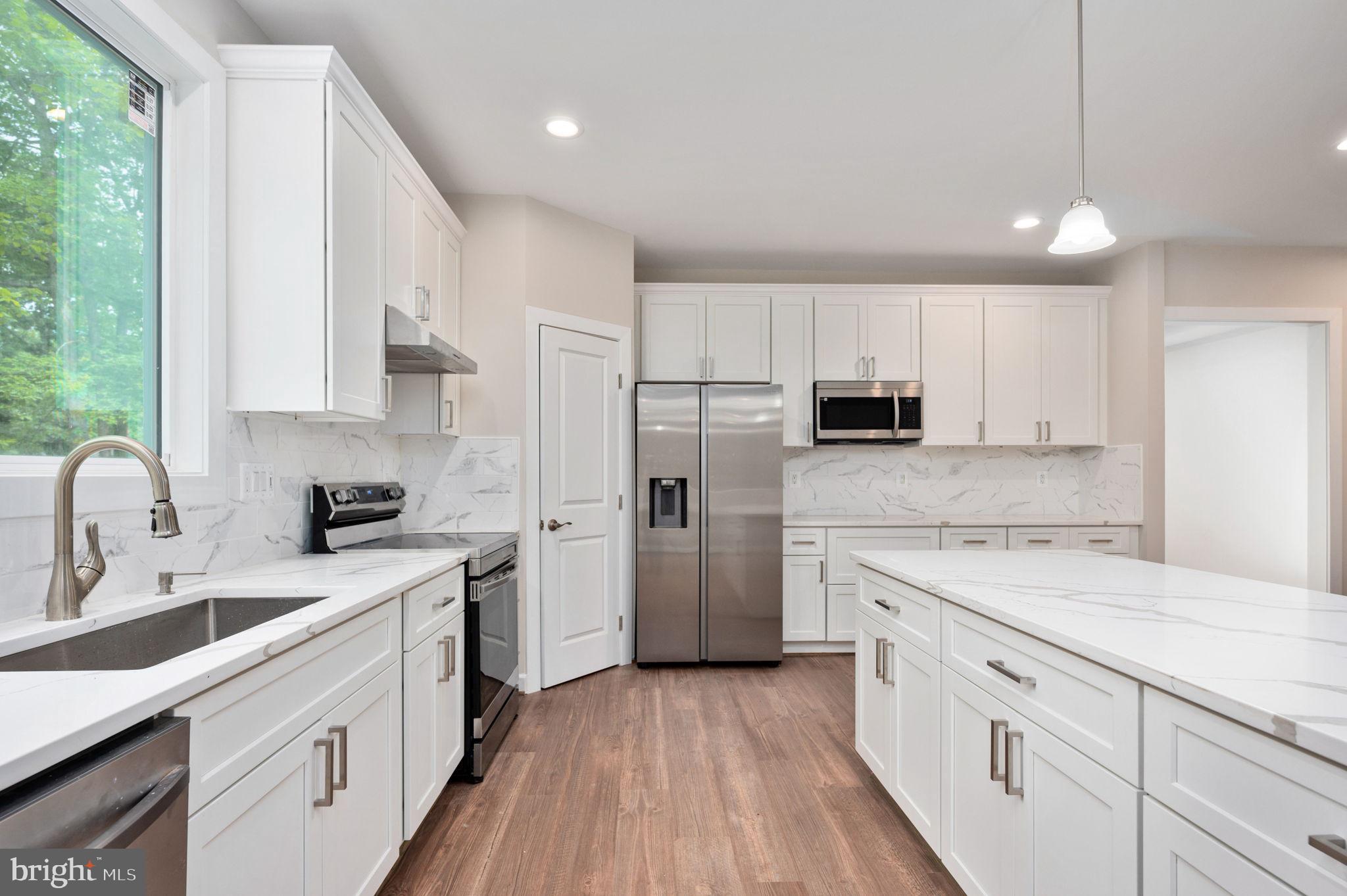 107 Gold Valley Road Locust Grove, VA 22508 - Photo 6 of 19 a kitchen with white cabinets sink and stainless steel appliances