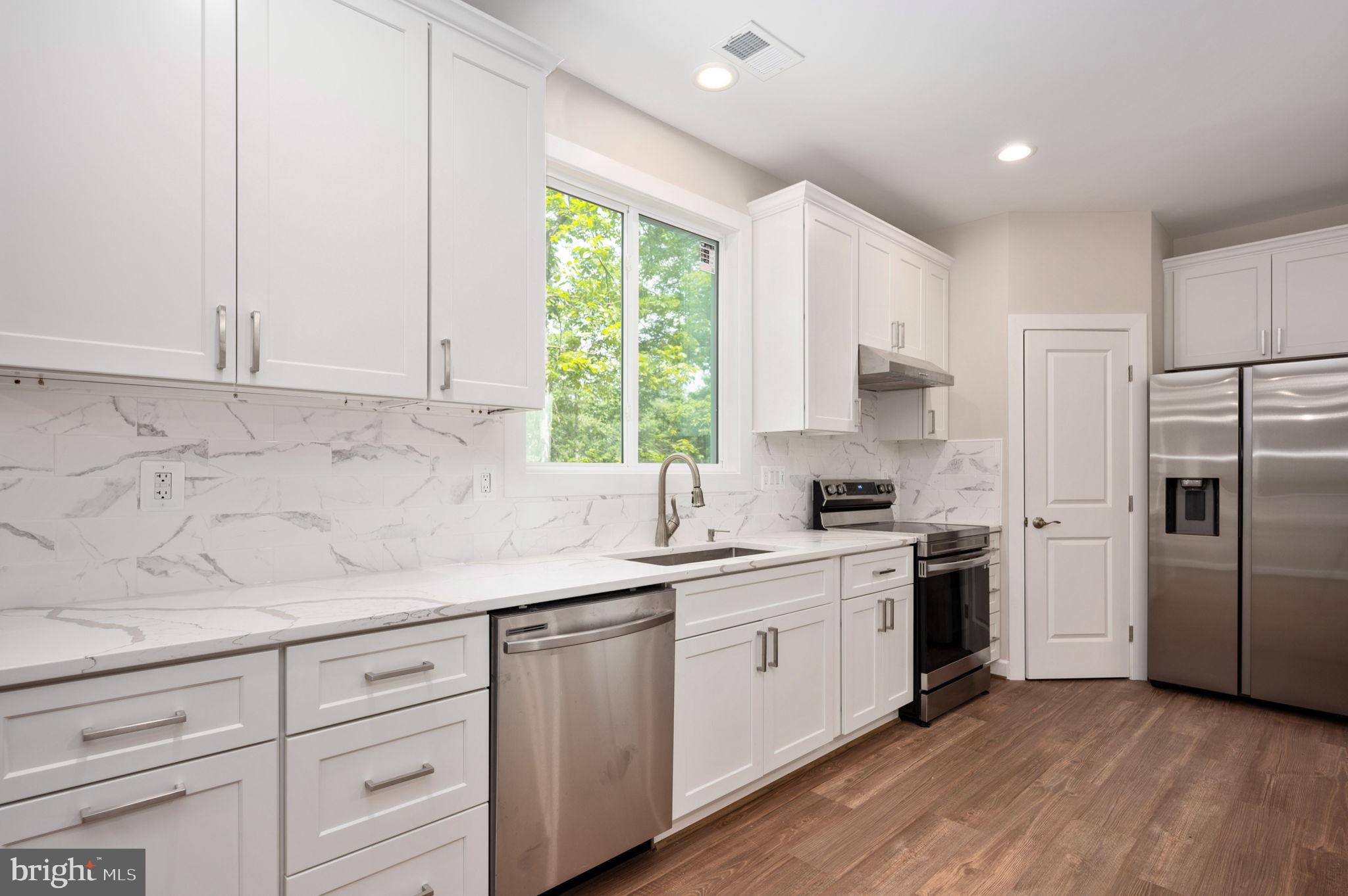 107 Gold Valley Road Locust Grove, VA 22508 - Photo 7 of 19 a kitchen with a sink white cabinets and stainless steel appliances