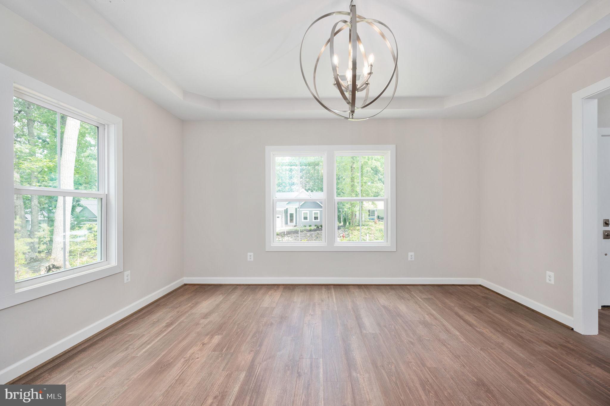 107 Gold Valley Road Locust Grove, VA 22508 - Photo 10 of 19 an empty room with wooden floor and windows