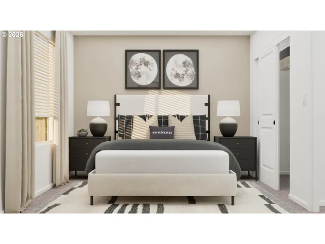 a bedroom with a bed a painting on the wall and a window