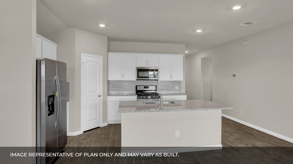 135 Morning Glory Loop Kyle, TX 78640 - Photo 7 of 22 a kitchen with stainless steel appliances granite countertop a refrigerator a stove and a sink