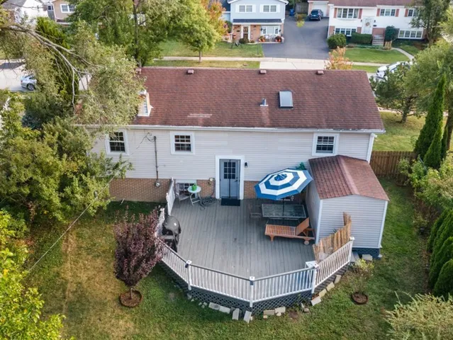 an aerial view of a house with a yard