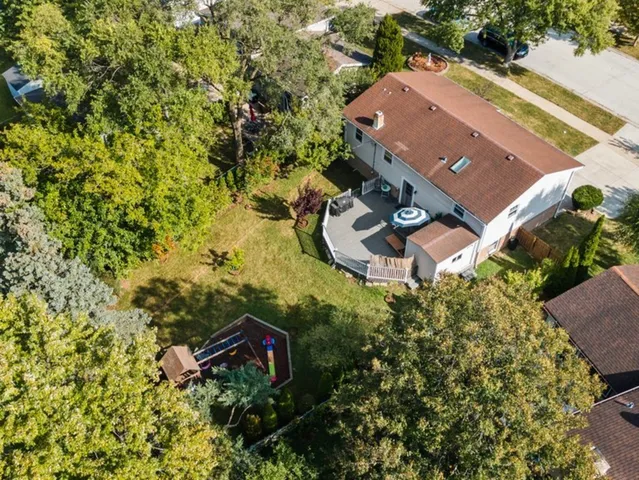 an aerial view of a house with a yard