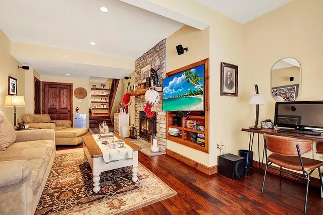 a living room with furniture a fireplace and a flat screen tv